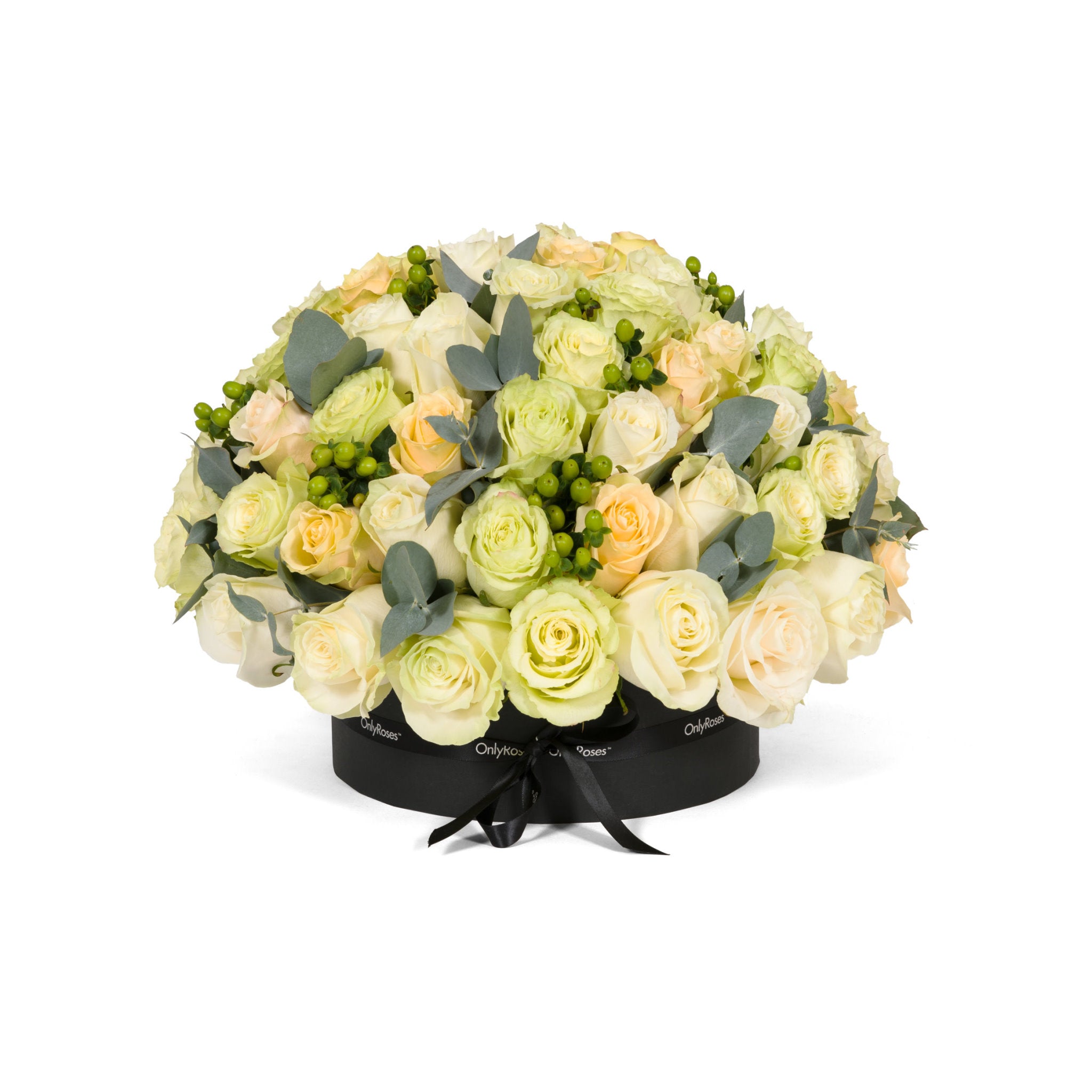 Bouquet of light-colored roses and greenery in a black heart-shaped box on a white background