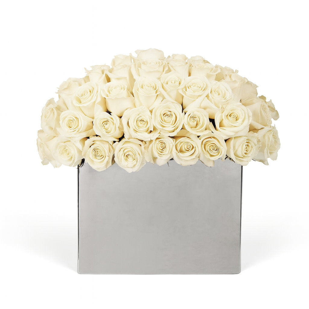 Bouquet of white roses in a silver box on a white background