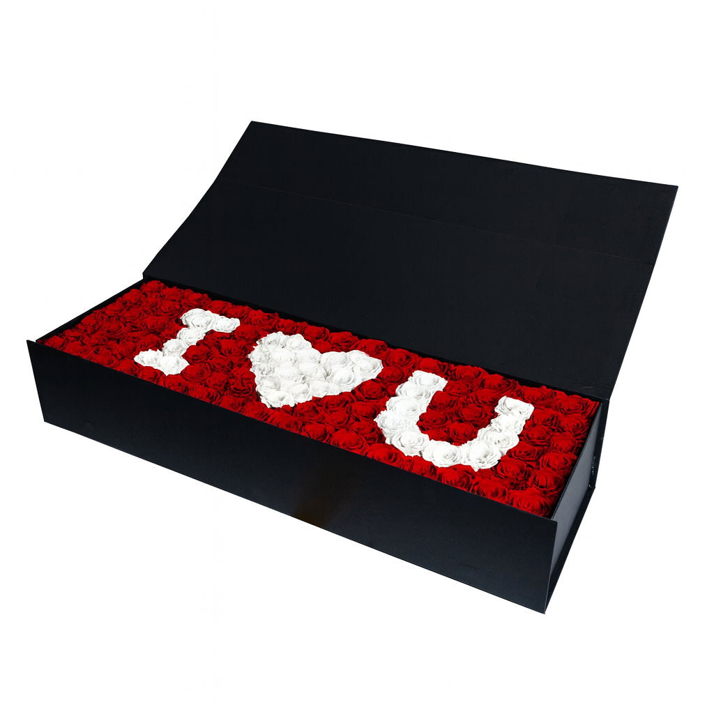 Black box with red rose petal message 'I ❤️ U' on a white background