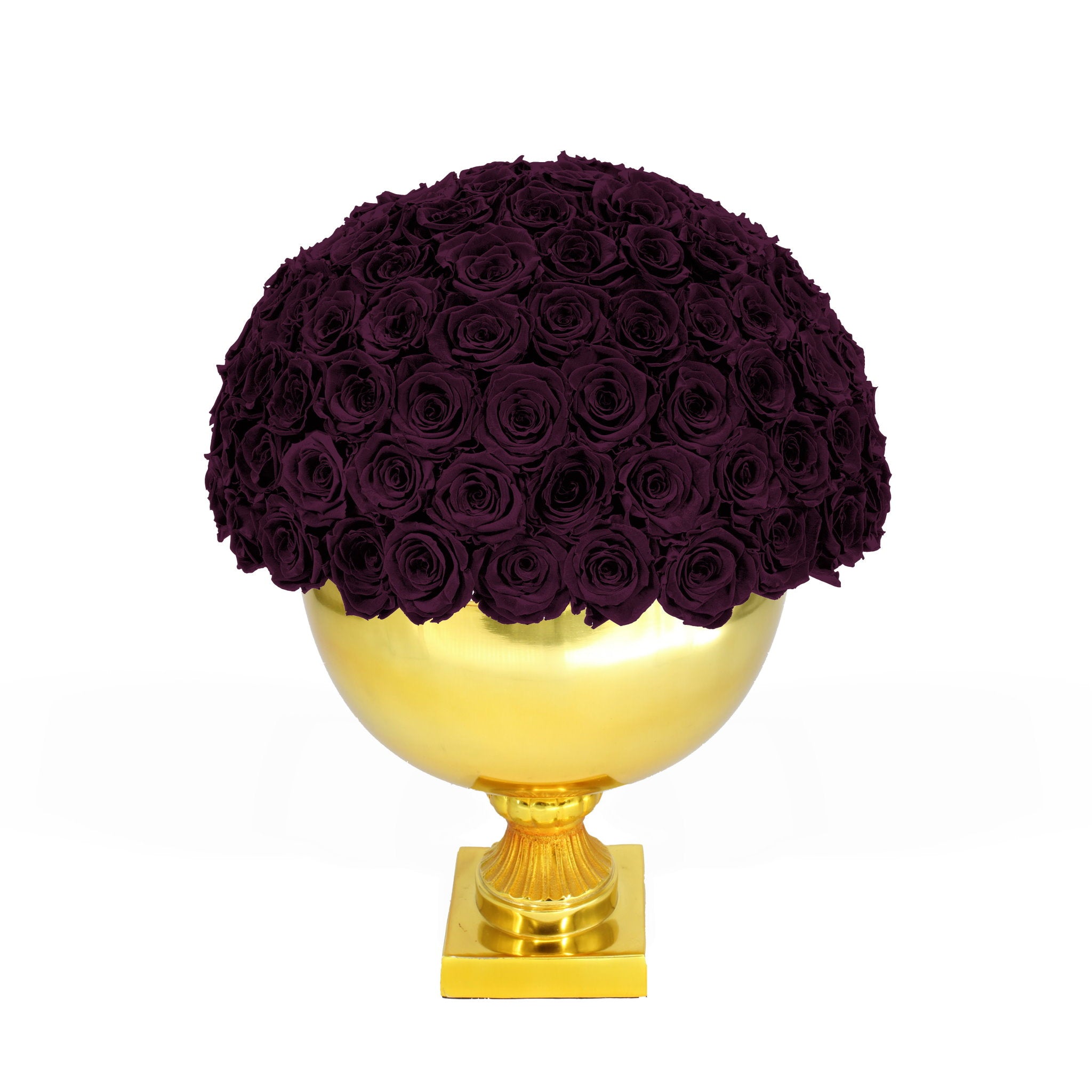 Decorative arrangement of purple roses on a gold pedestal against a white background