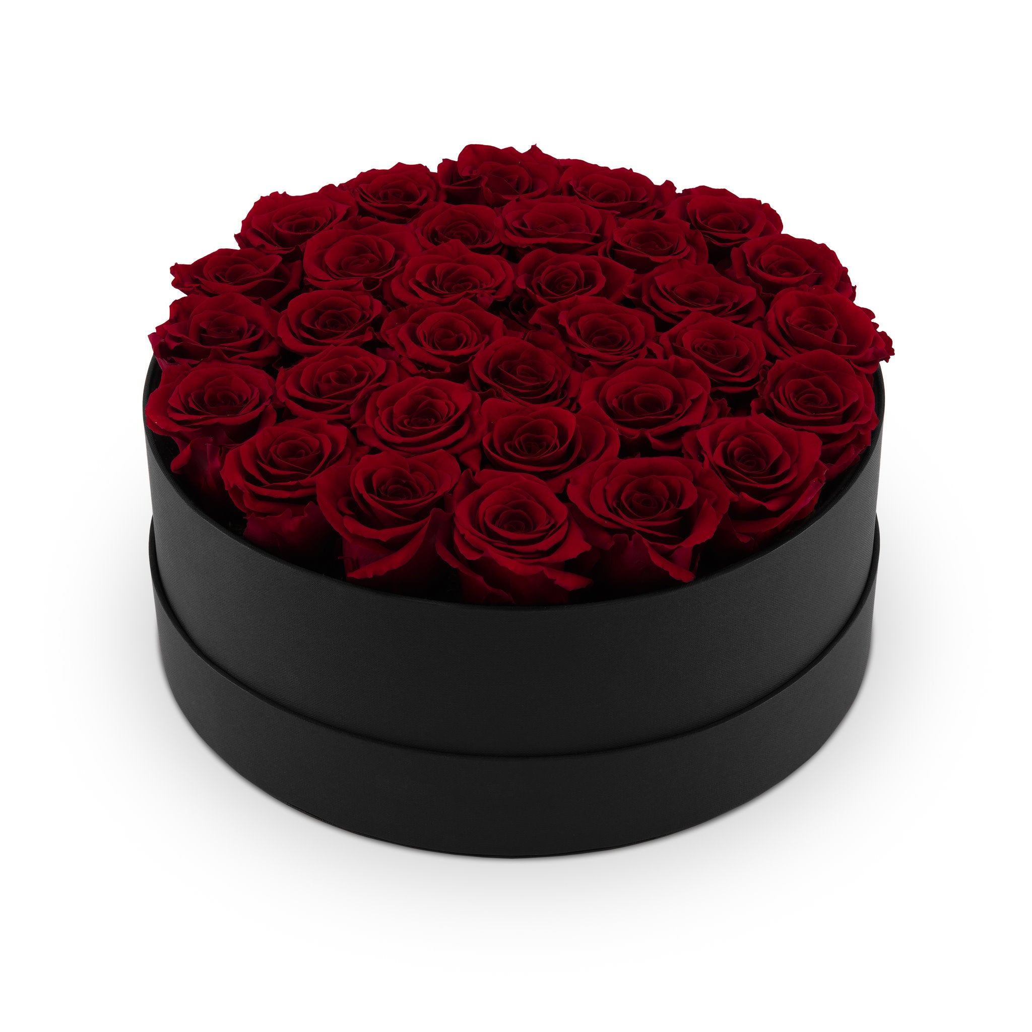 Black round box filled with red roses on a white background