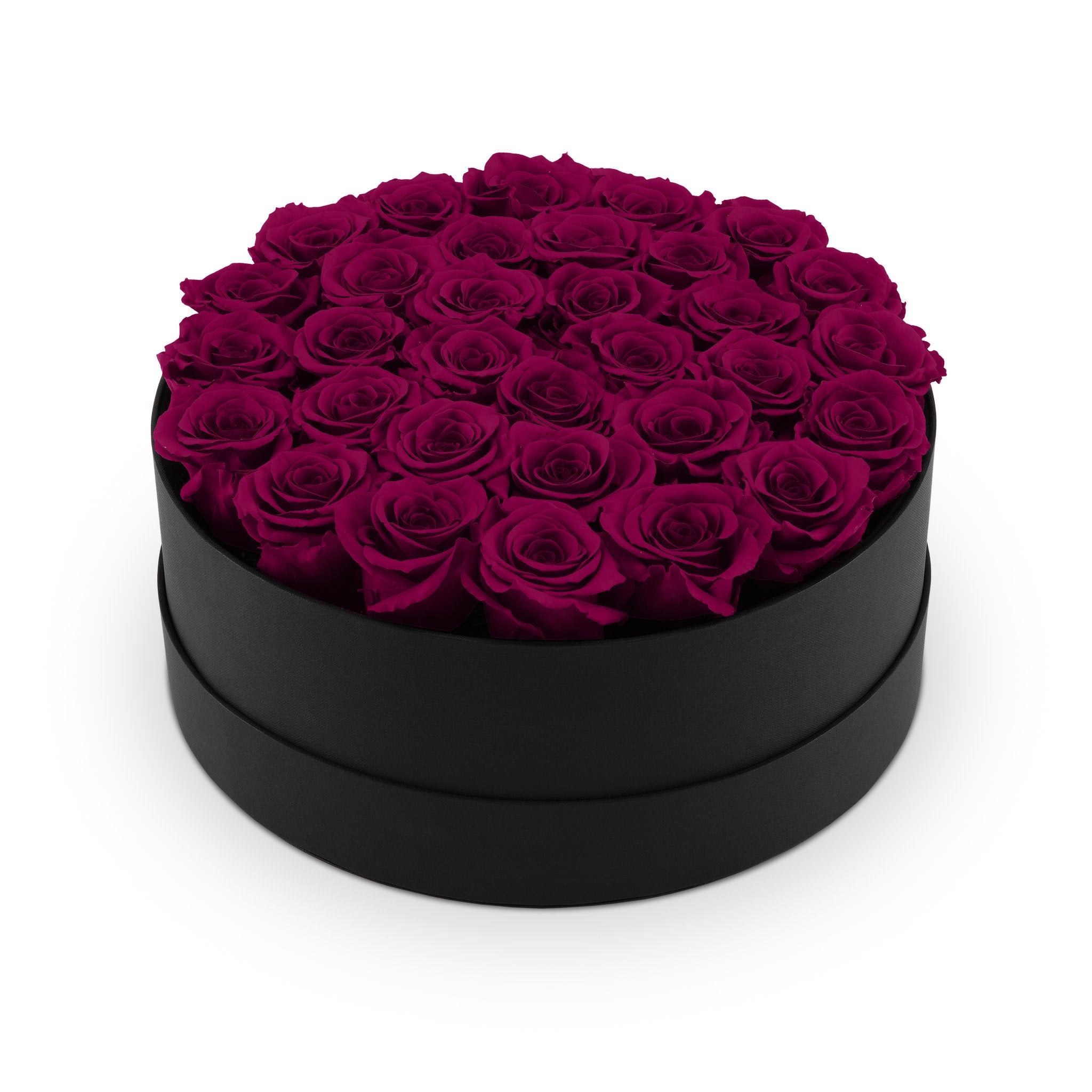 Black round box filled with purple roses on a white background