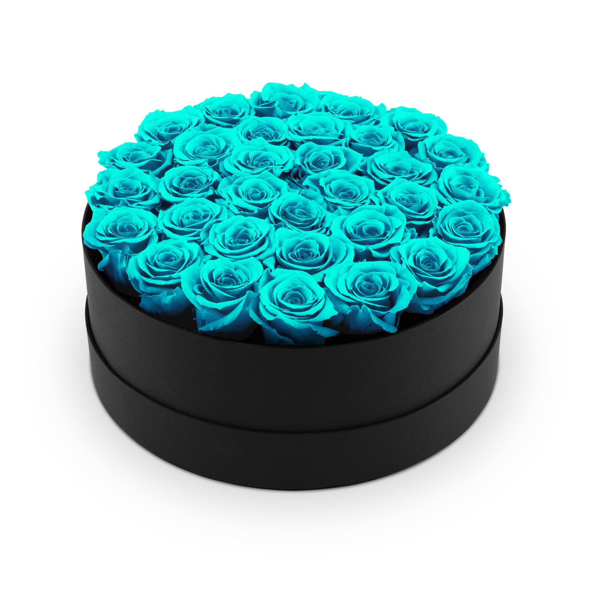 Heart-shaped box filled with turquoise roses on a white background