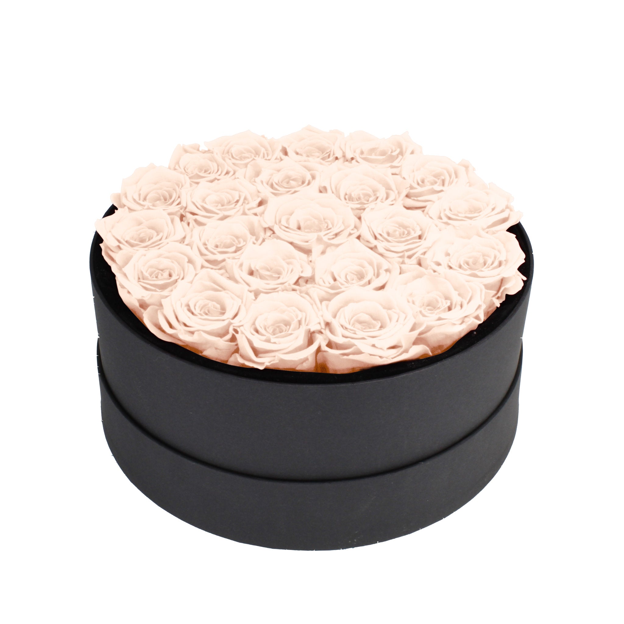 Black round box filled with pink roses on a white background
