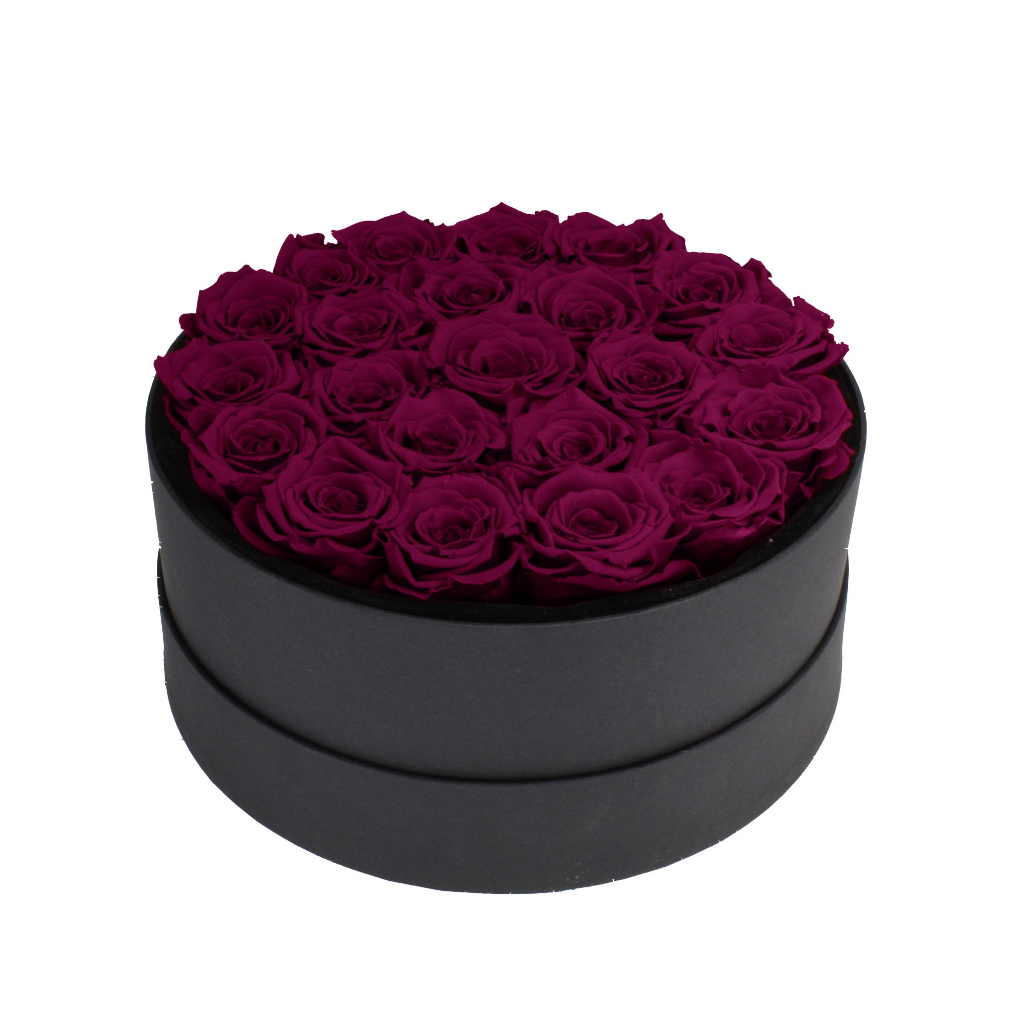 Black round box filled with purple roses on a white background