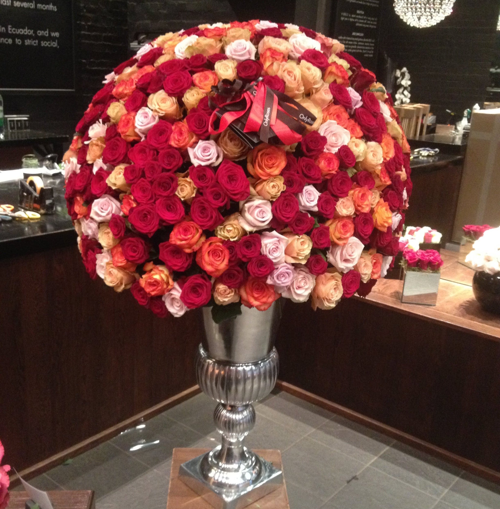 Decorative object made of multicolored roses on a stand with a blurred background
