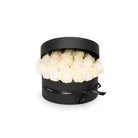 Black round box with white flowers on a white background