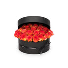 Black box with red and orange roses on a white background