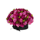 Bouquet of pink roses in a black box on a white background