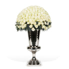 Silver urn with a large arrangement of white roses on a white background