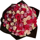 Bouquet of red, pink, and white roses wrapped in black paper on a white background
