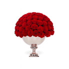 Bouquet of red roses in a decorative silver vase on a white background