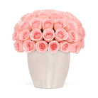 Bouquet of pink roses in a white vase on a white background