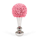 Decorative object with pink rose ball and silver base on a white background