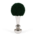 Decorative topiary ball made of dark green roses on a silver stand against a white background