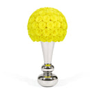 Yellow rose ball on a silver stand against a white background