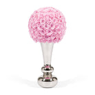 Decorative item with pink rose ball on a silver stand against a white background