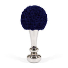 Decorative object with blue rose ball on a silver stand against a white background