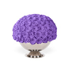 Purple rose ball on a white pedestal against a white background