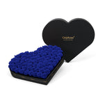 Heart-shaped box of royal blue roses with 'Only Roses' branding on a white background