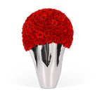 Silver vase with a large bouquet of red roses on a white background