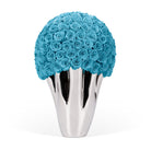 Silver vase with blue roses on a white background