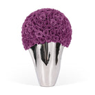 Silver vase with a purple rose arrangement on a white background