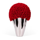 Silver vase with red roses on a white background