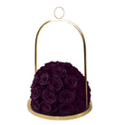 Purple roses in a gold holder on a white background