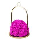 Pink roses in a gold dome-shaped container on a white background