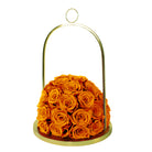 Gold dome holding a bouquet of orange roses on a white background
