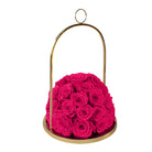 Pink roses in a gold holder on a white background