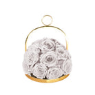 Gold hoop container with white roses on a white background