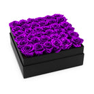 Black box filled with purple roses on a white background