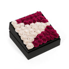 Black box with pink and white rose design on a white background