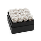 Black box with white roses on a white background