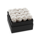 Black box with white roses on a white background
