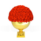 Gold vase with red roses on a white background