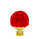 Bouquet of red roses in a gold vase on a white background