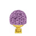 Purple rose ball on a gold pedestal against a white background