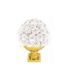 Decorative sphere made of white roses on a gold base against a white background
