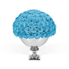 Bouquet of blue roses in a silver vase on a white background