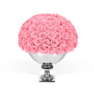 Bouquet of pink roses in a silver vase on a white background
