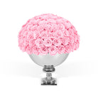 Pink roses in a silver vase on a white background