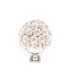 Decorative sphere made of white roses on a white background