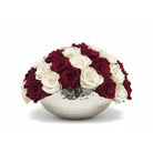 Bouquet of red and white roses in a silver bowl on a white background