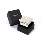 Black box with 'Only Roses' branding containing a small arrangement of white roses on a white background.
