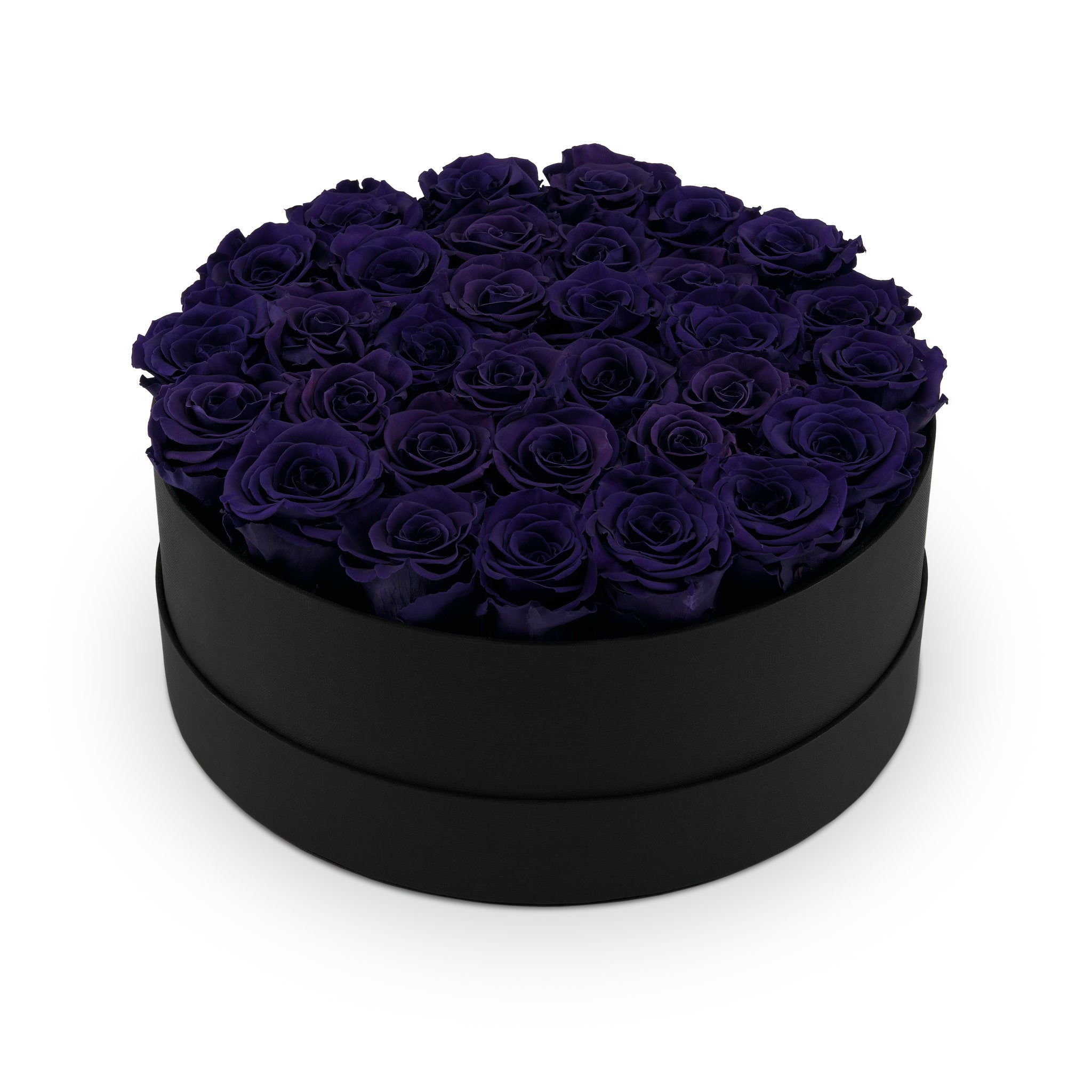 Black round box filled with purple roses on a white background