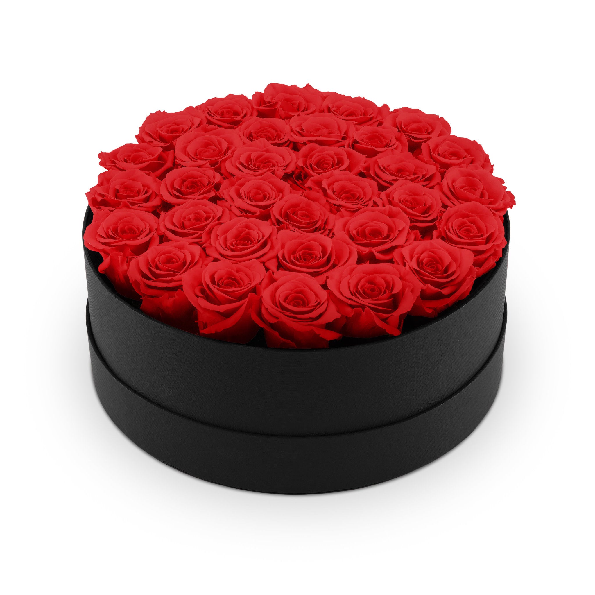 Black round box filled with red roses on a white background
