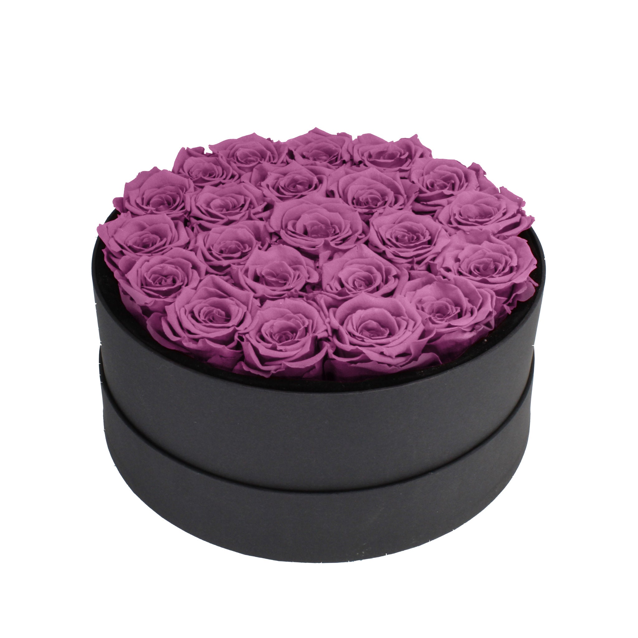 Black round box filled with purple preserved roses on a white background